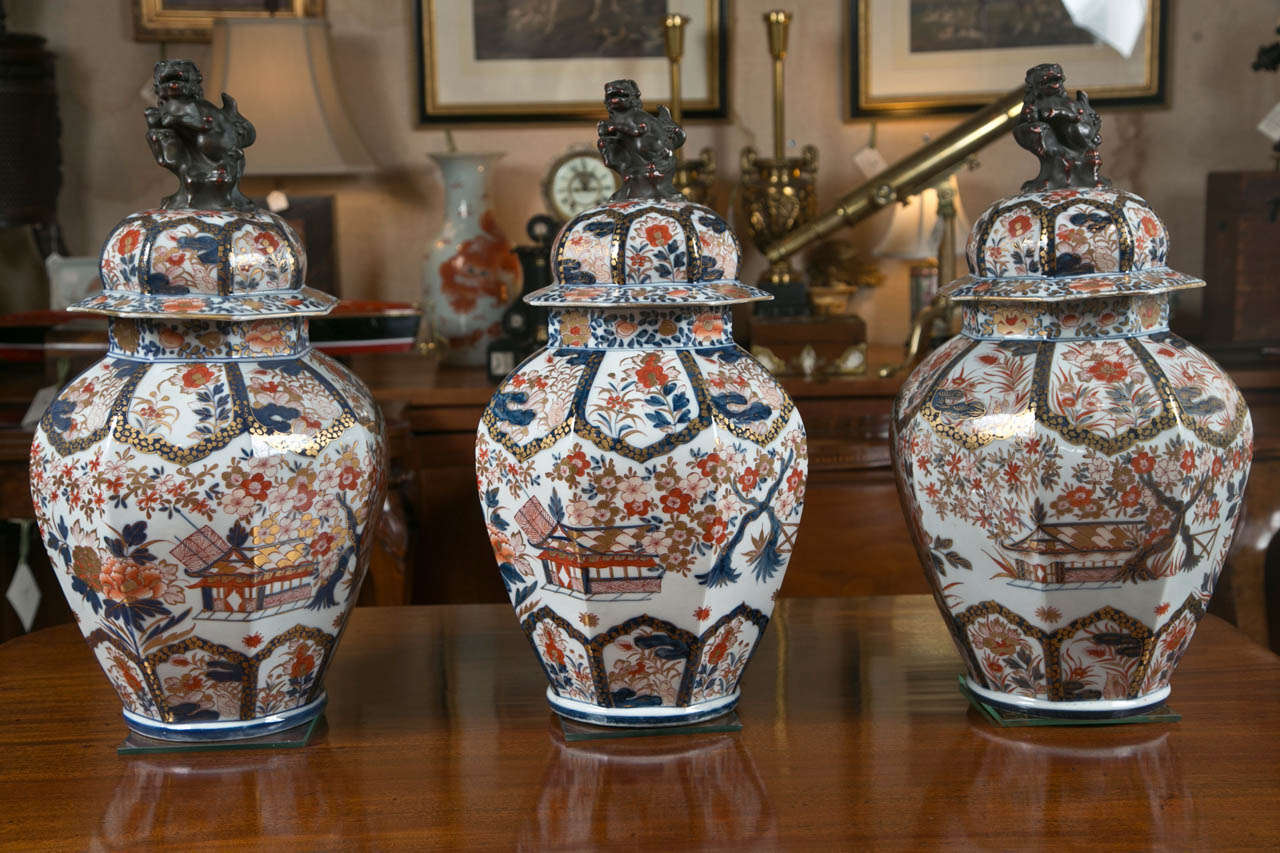 Of a near-monumental size, this set of three lidded Imari urns is expertly executed and decorated. With fu dog handled lids and a pleasing octagonal shape, this is a highly desirable trio that would raise the decorative value of just about any