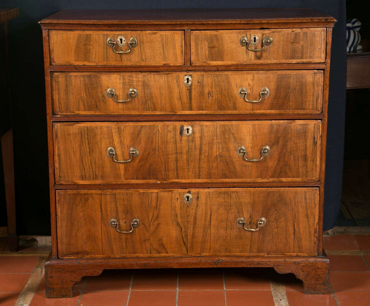 Herringbone crossbanding on each drawer front is a Classic dash of style on this medium-sized chest of five drawers on bracket feet. Not too big for use next to a large bed and not too small for and entryway, it could find a home just about anywhere