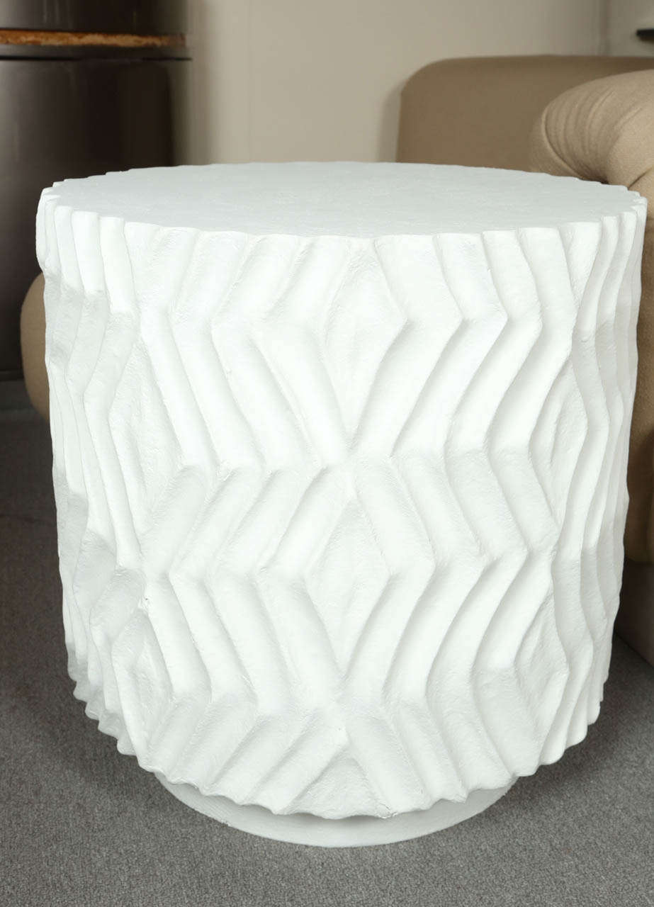 Pair of ceramic end tables with a bold zig zag molded pattern.  They are up on smaller bases, though they all made in one piece.   They have been painted white and are very John Dickinson.