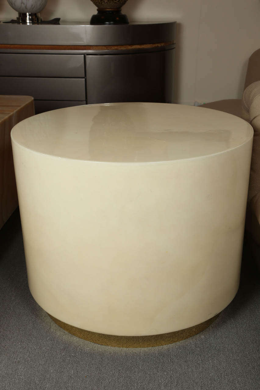 Simple and elegant lacquered parchment dum table by Steve Chase.
The table is an Ivory lacquered parchment finish a brass trim appointment to the base. The table is in great condition with one small minimal hairline crack to the reverse side which