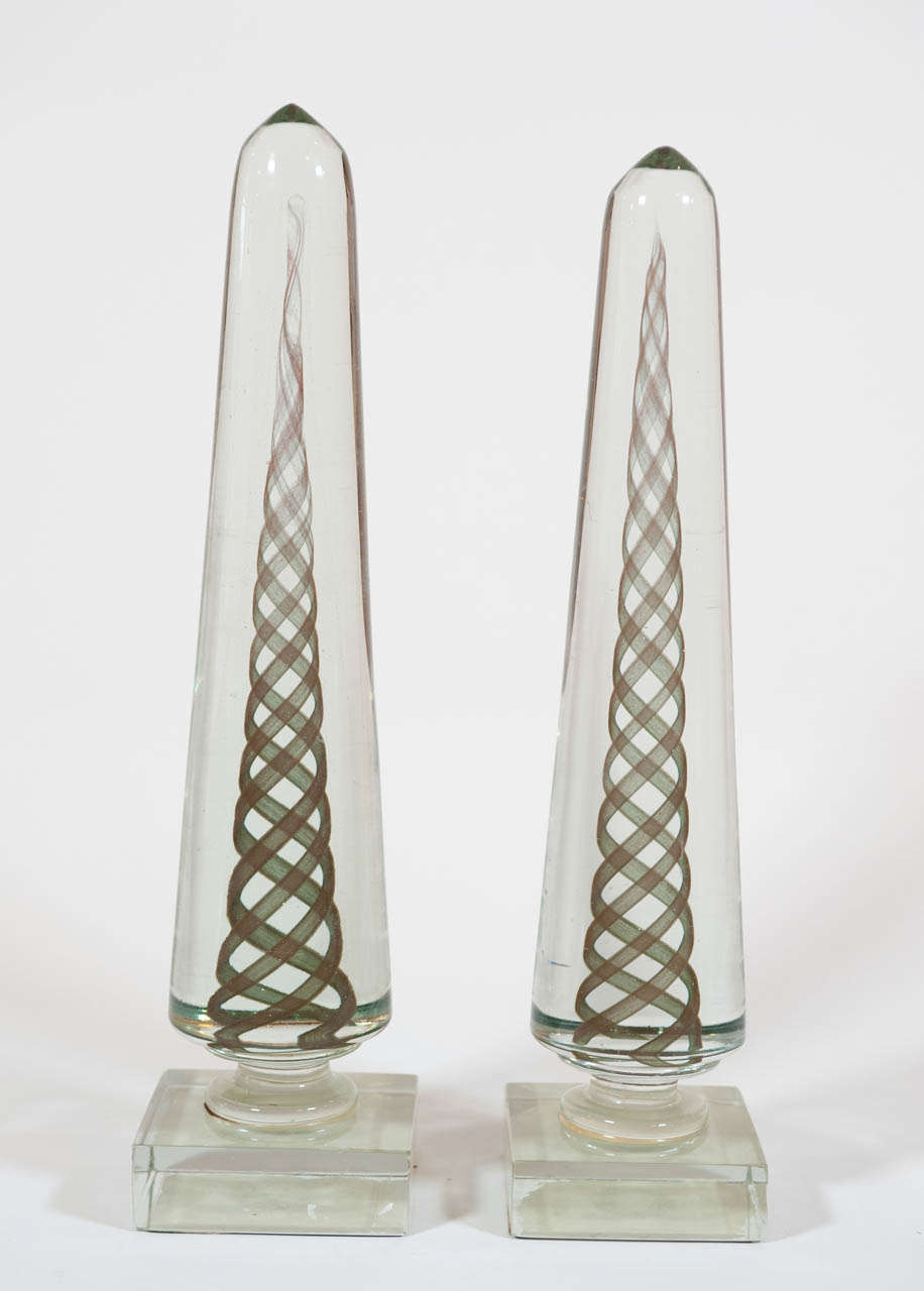 Clear glass obelisks with internal spiral aventurine motif.