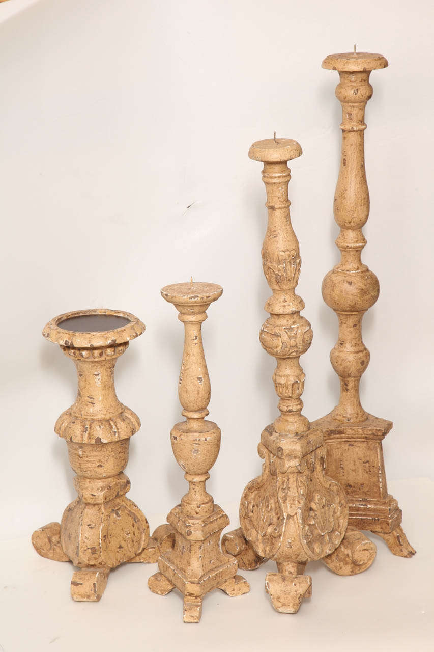 A selection of Portuguese candlesticks, painted in natural color. Priced and sold separately. Largest size and price shown below.