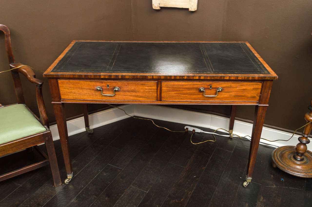 English mahogany writing table with leather top, circa 1860, with two drawers, finished on back side with false drawers.