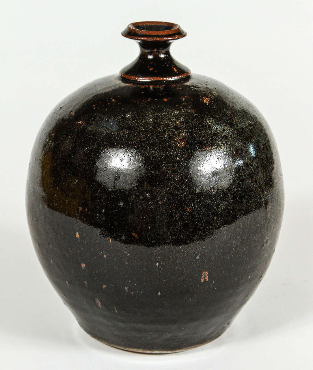 Vintage pottery pot with black speckle glaze, circa 1970s.