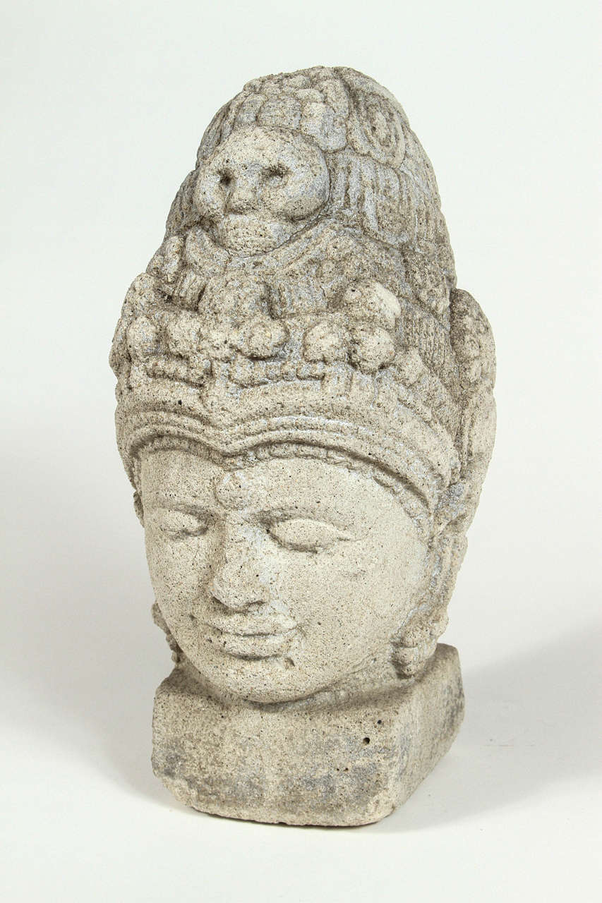 Carved stone Buddha head garden ornament.
