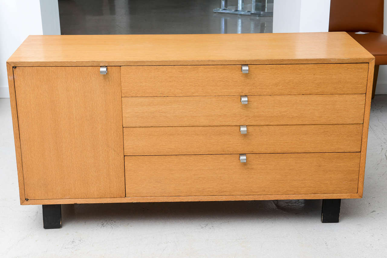 Mid-Century Modern cabinet or dresser made by American designer George Nelson for Herman Miller. Cabinet is made out of oak and ebonized wooden legs, with metal pulls.
