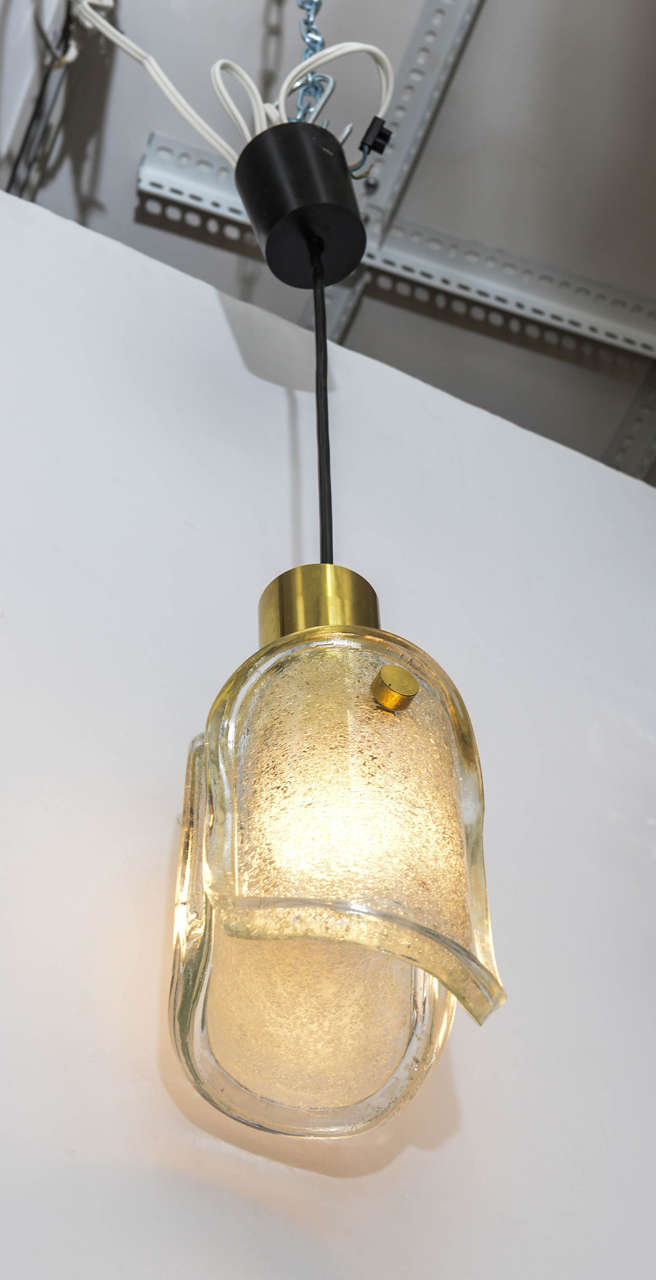 Vintage Limburg glass and brass pendant light fixture. The glass is champagne in tint and each has a single socket. The socket houses a 60 watt bulb with standard diameter. We have five available sold individually.