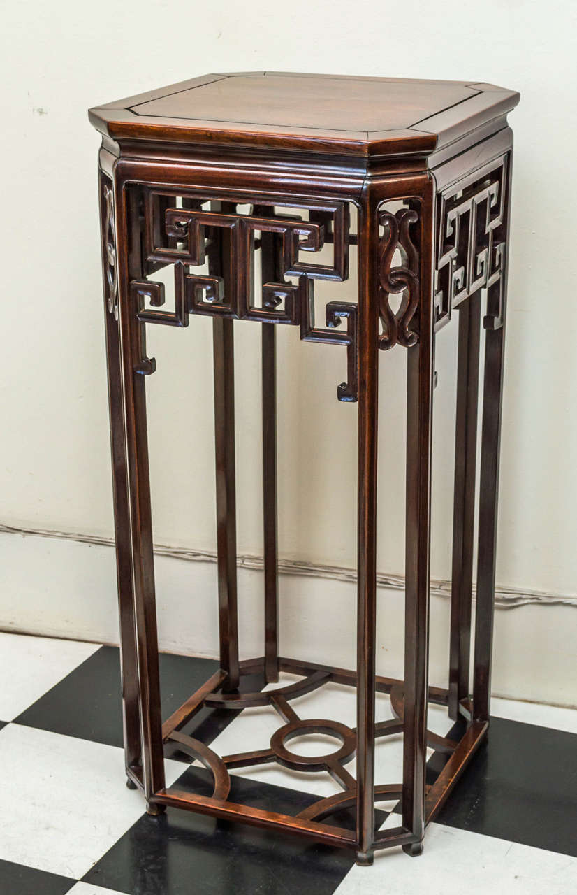 Chinese li wood, (rosewood), octagonal form incense stand. Circa 1860-80
Intricate octagonal form with eight legs bracketed and circular stretcher. Good faded color and figured tight grained wood. Faceted shaping to the legs and concave shaping to