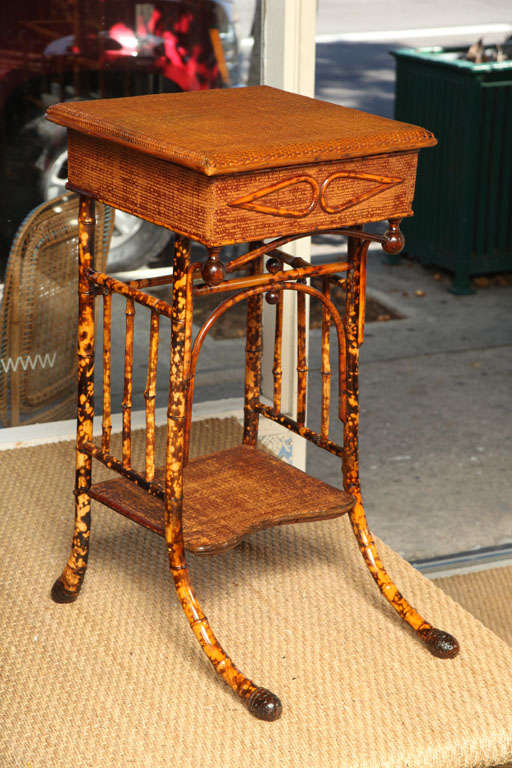 Very original bamboo sewing-side table with rattan. Top of table opens for storage . Bamboo Root Feet.