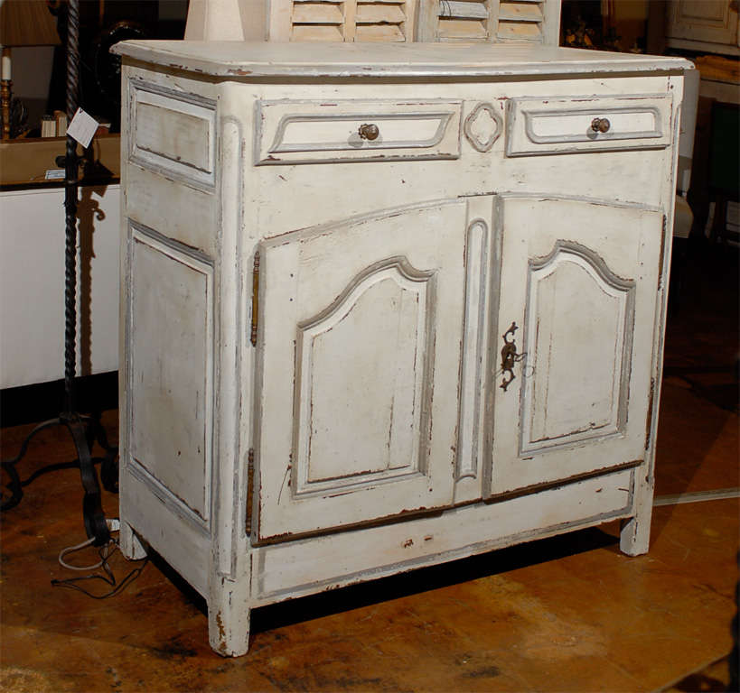 Early 19th century French Provincial paint decorated buffet, the rectangular top surmounting two short drawers above a double door cabinet opening to reveal two shelves and raised on straight feet, from Uzes, France.
