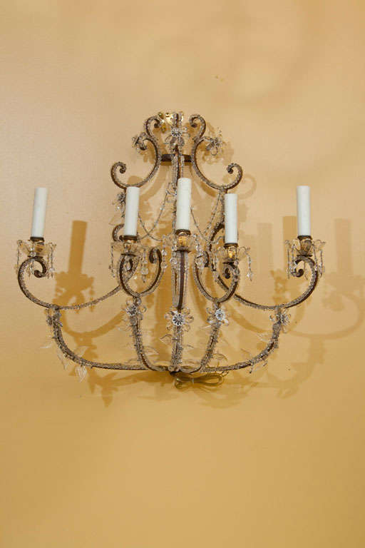 Monumental pair of Italian Baroque style sconces adorned with crystals and glass beads and comprised of five lights, re-electrified for US