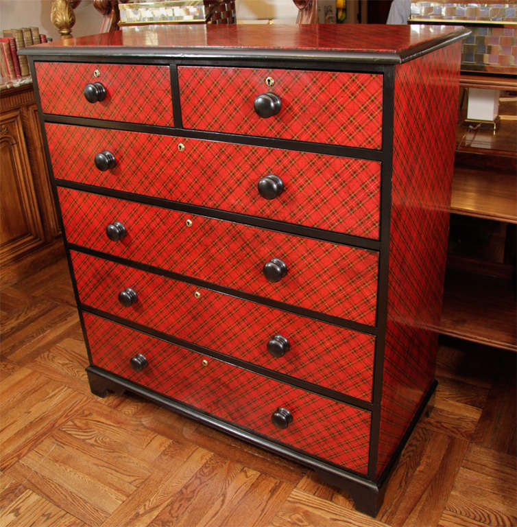 Victorian Ebonized Chest in Modern Red Tartan Plaid Decoupage with Two Short Drawers Over Four Long Drawers and Black Pulls; Raised on Bracket Feet. England, 19th Century <br />
<br />
44 inches wide x 21 inches deep x 47 inches high