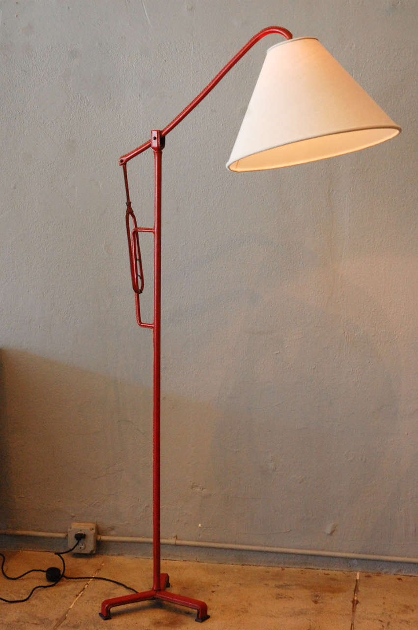 an original jacques adnet floor lamp wrapped in his signature leather.