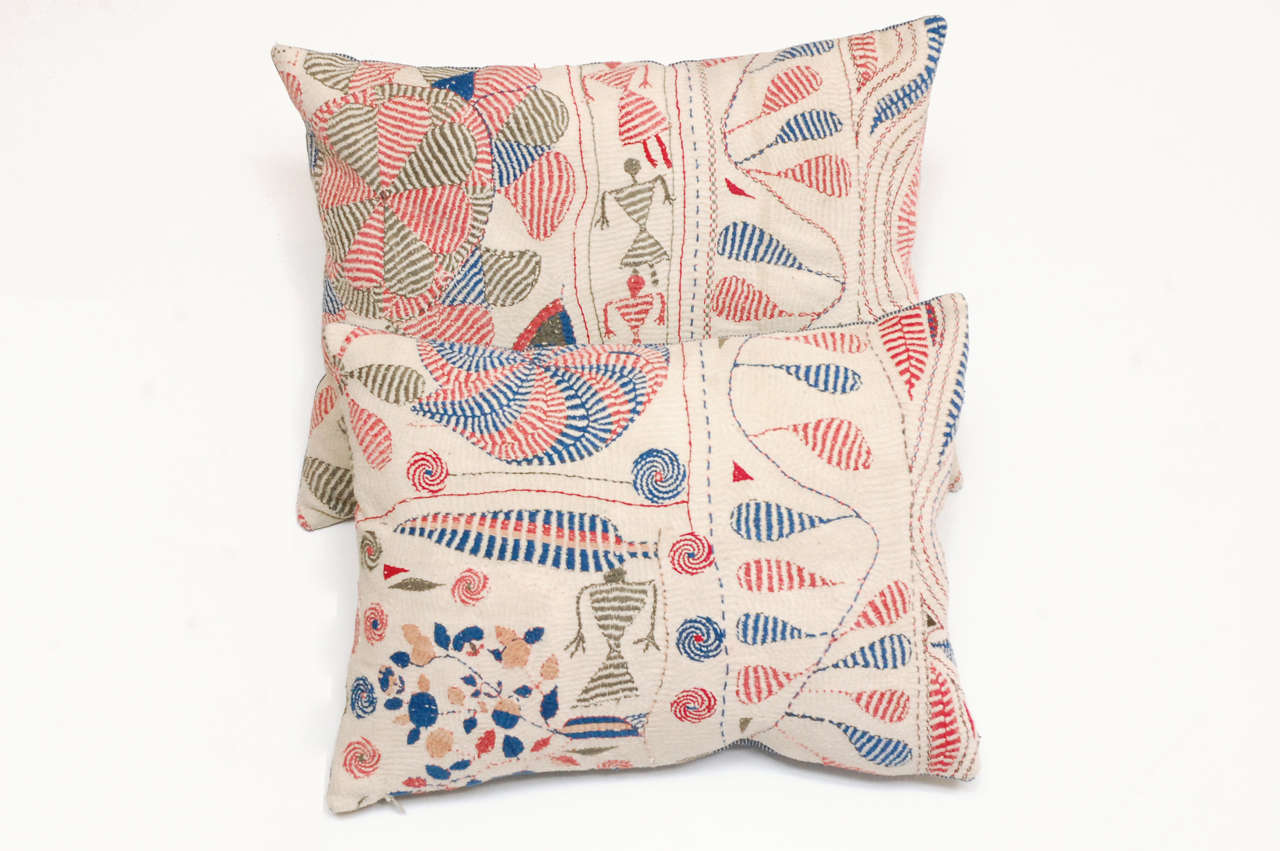 Made from an antique Indian Kantha quilt. Tiny all over quilting stitches with embroidery on top. Depicting figurative characters, flowers, and pin wheels. Indigo Blue and white ticking backing fabric with invisible zipper; feather and down insert. 