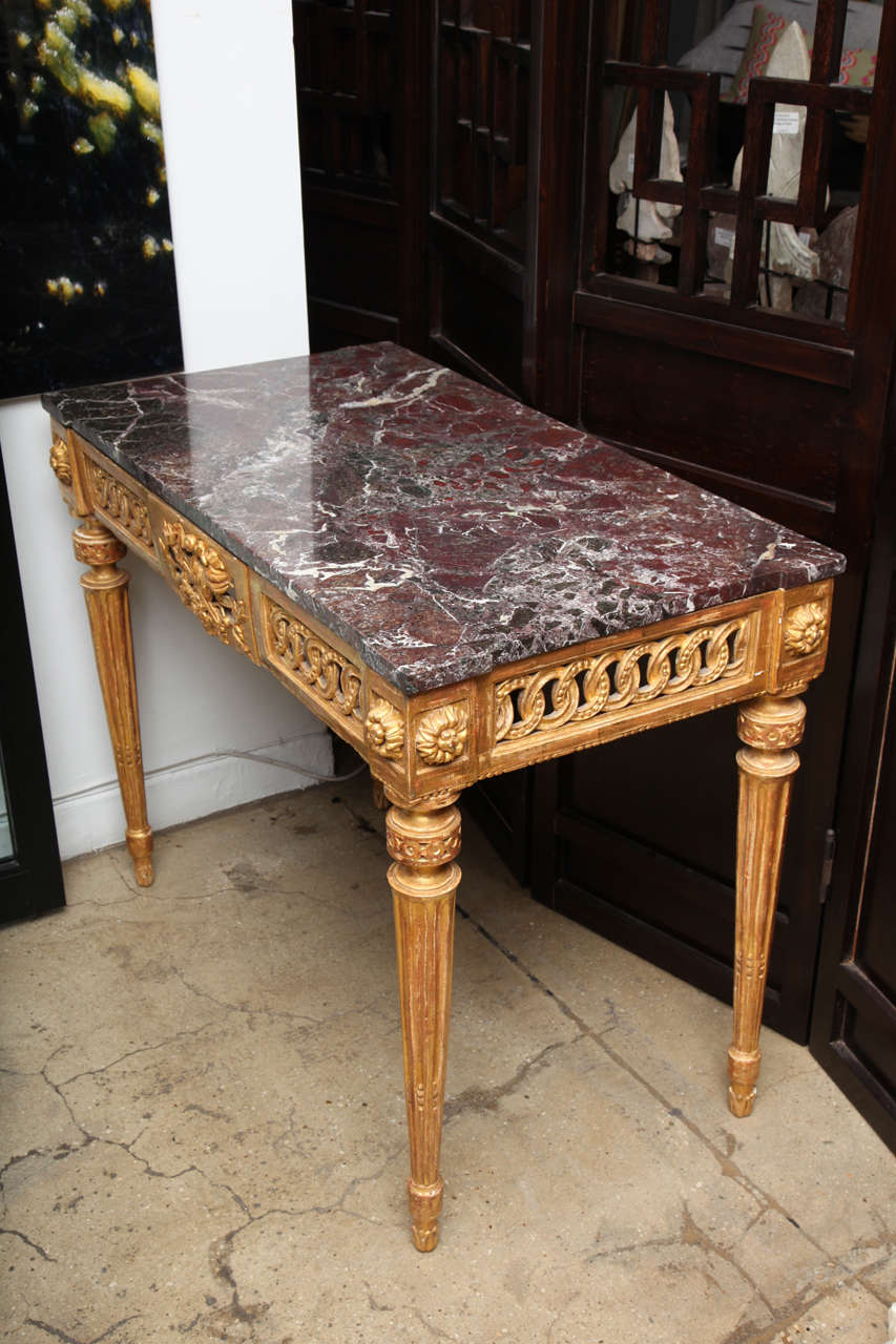 An Italian giltwood and marble-top console table, late 18th century. Measures: 33 1/2