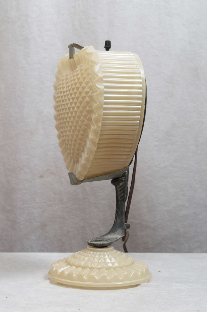 This very rare art deco lamp is really quite special.  The heart shaped upper portion, which lights up, really gives off a warm glow.   We have it pictured in a catalog from 1947.  The item was made by A.F. Klingsberg. We have a photo of the ad with