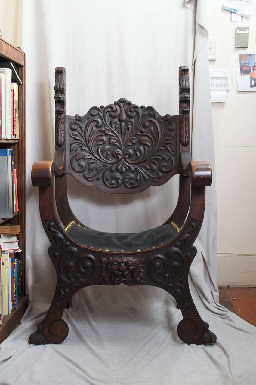 This is by far the grandest Roman chair we have ever come across.  The proportions and detailed carving make this one fit for a Roman Emperor.  This chair retains its beautiful original dark oak finish and has been upholstered in leather.  Take note