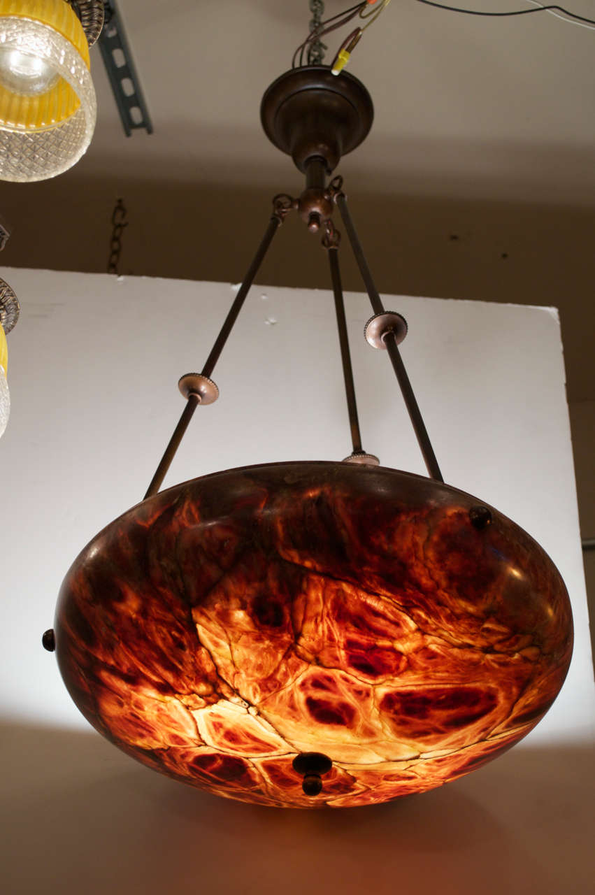 This certainly is one of the most amazing alabaster chandeliers we have ever offered.  As good as the photos are, it's even better in person.  It does resemble a tortoiseshell, but we guarantee you we harm no animals to bring this to you.  I don't