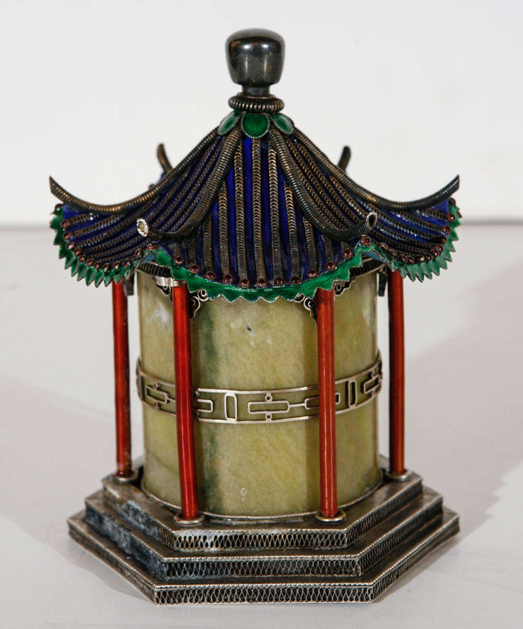 Vibrant, jade, silver and enamel pagoda canister on a stepped base.