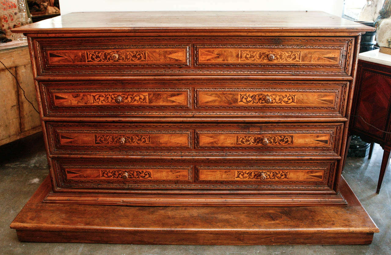 Large, four-drawer, inlaid, commode with sea-serpent details- the whole upon a raised, 19th c. base.