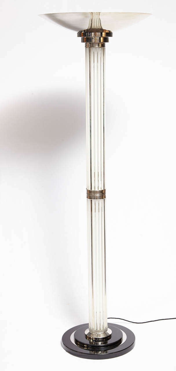 Pair of Art Deco torchieres by Petitot. Tubular glass in chromed metal frame with a chrome-plated metal shade. There are four bulbs behind the glass structure and one bulb behind the top shade.