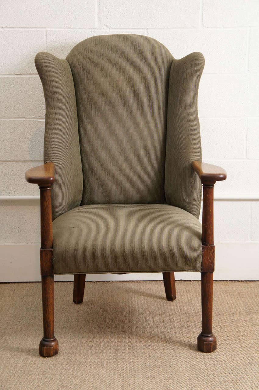 Here is a great wing back chair in a dark oak finish and corded fabric.
The chair has a vintage finish throughout.