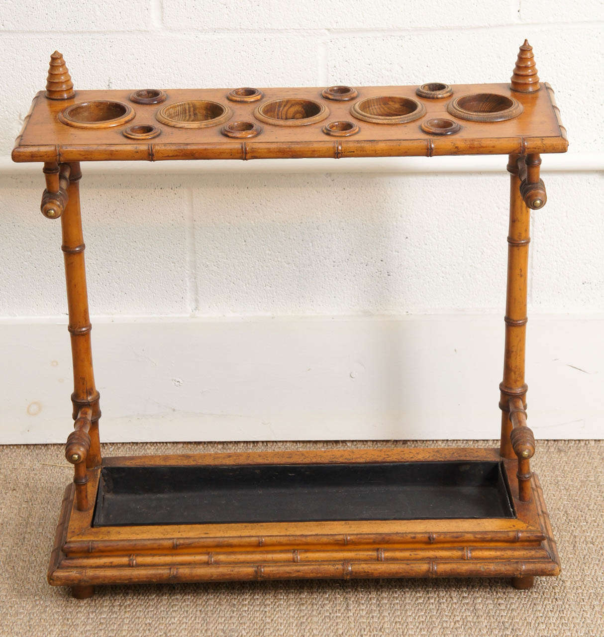 Here is an English Victorian cane and umbrella stand in a bamboo motif with a black lacquered zinc liner.