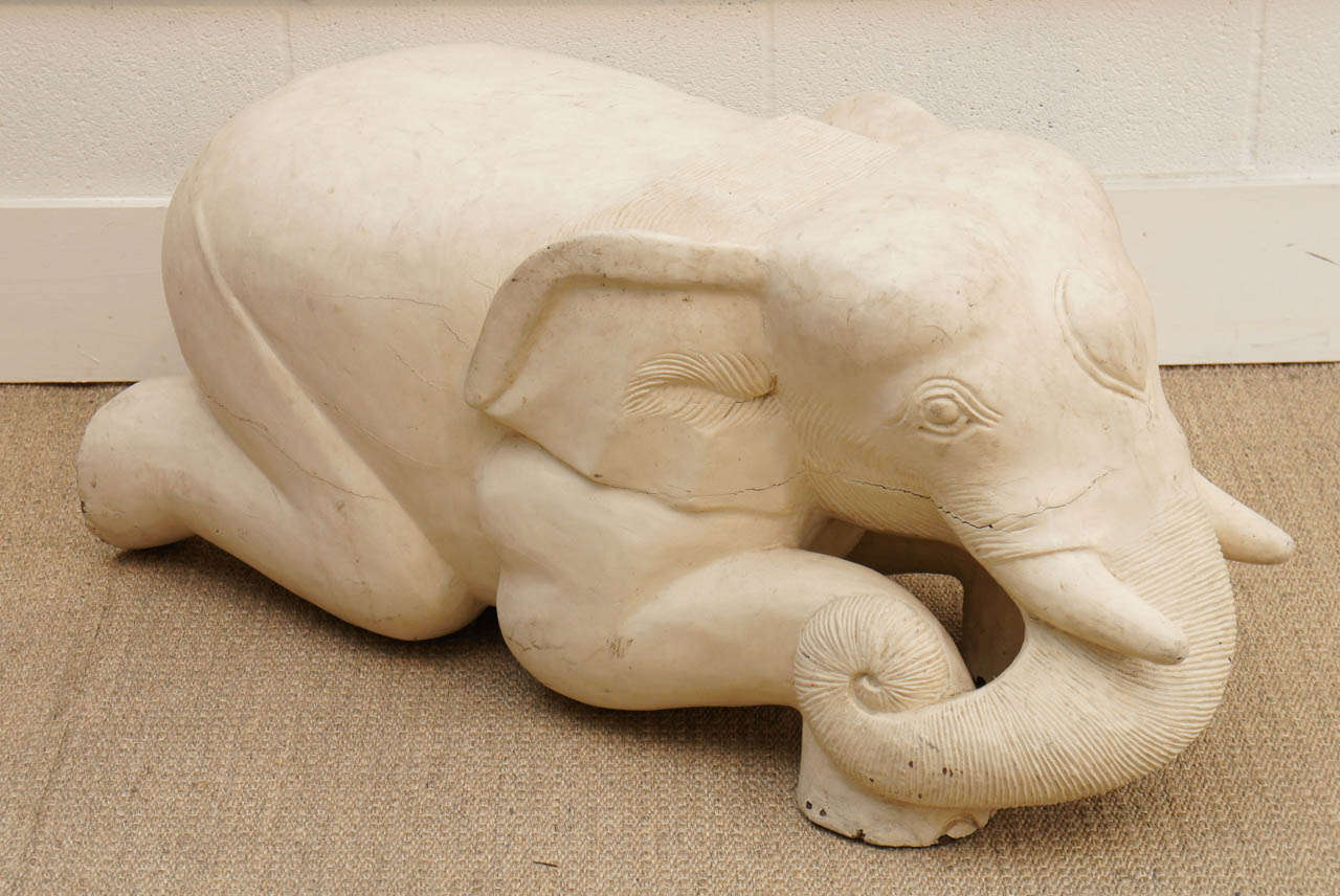 Here is a charming white elephant that could be used as a bench seat or a table. This is a solid wood sculpture that is carved and has a skim plaster coated finish with great patina.