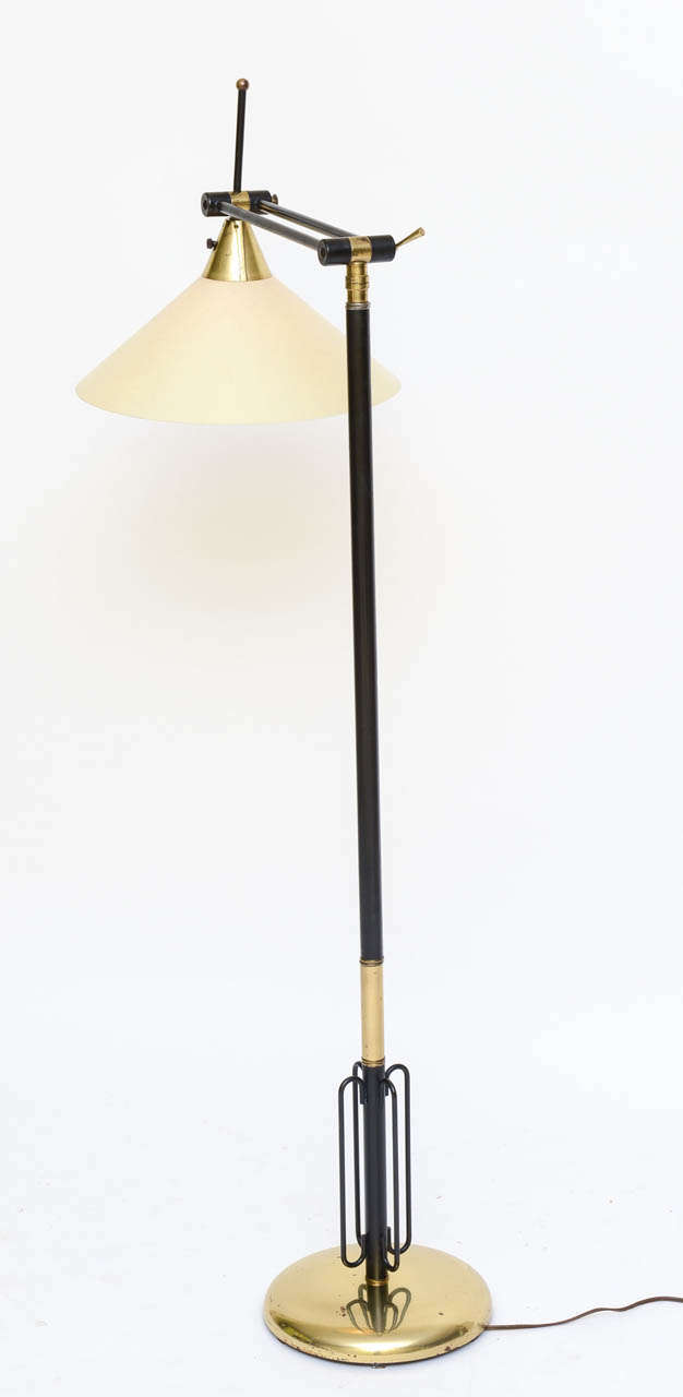 ...SOLD...Most likely Italian, this exceptional 1950s floor lamp is fully articulated with an upper arm that moves in all directions and a fiberglass cone diffuser  that can be angled endlessly as well.  Appointed in brass and black patinated