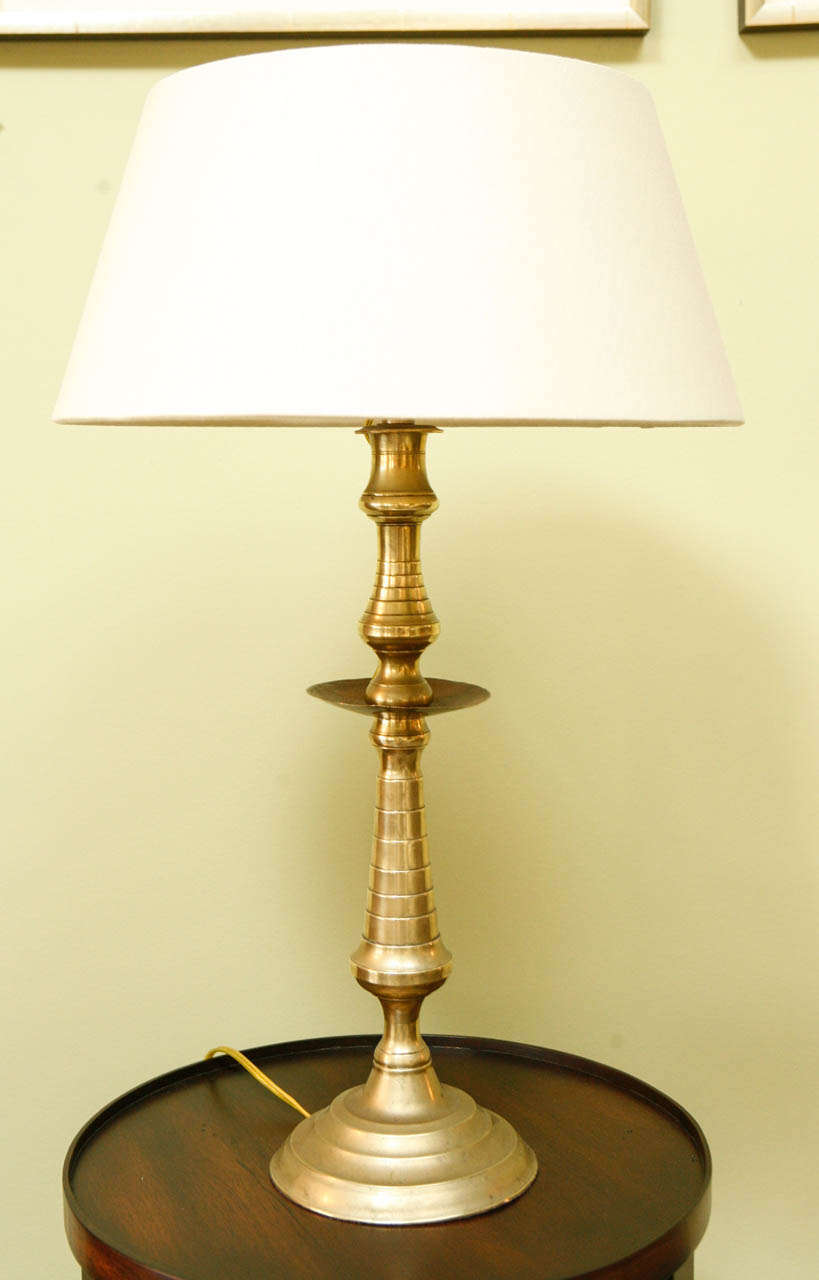 A Continental Brass Candlestick, early 19th c., now wired as a lamp with a custom rolled edge linen shade
