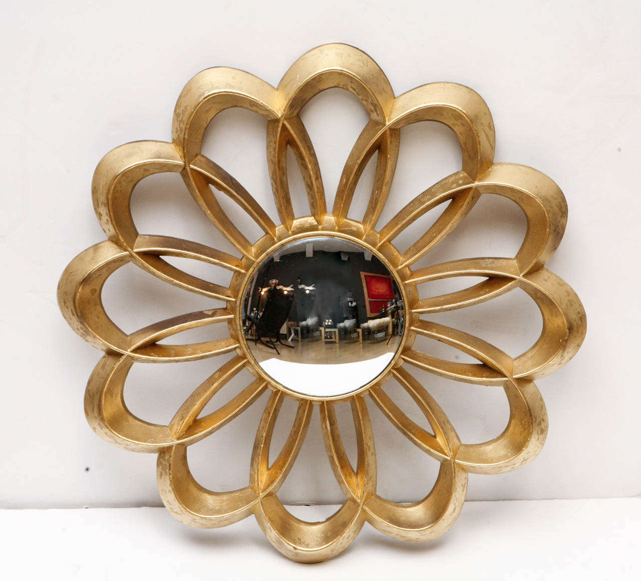 Floral Shaped convex mirror with gold gilt finish.