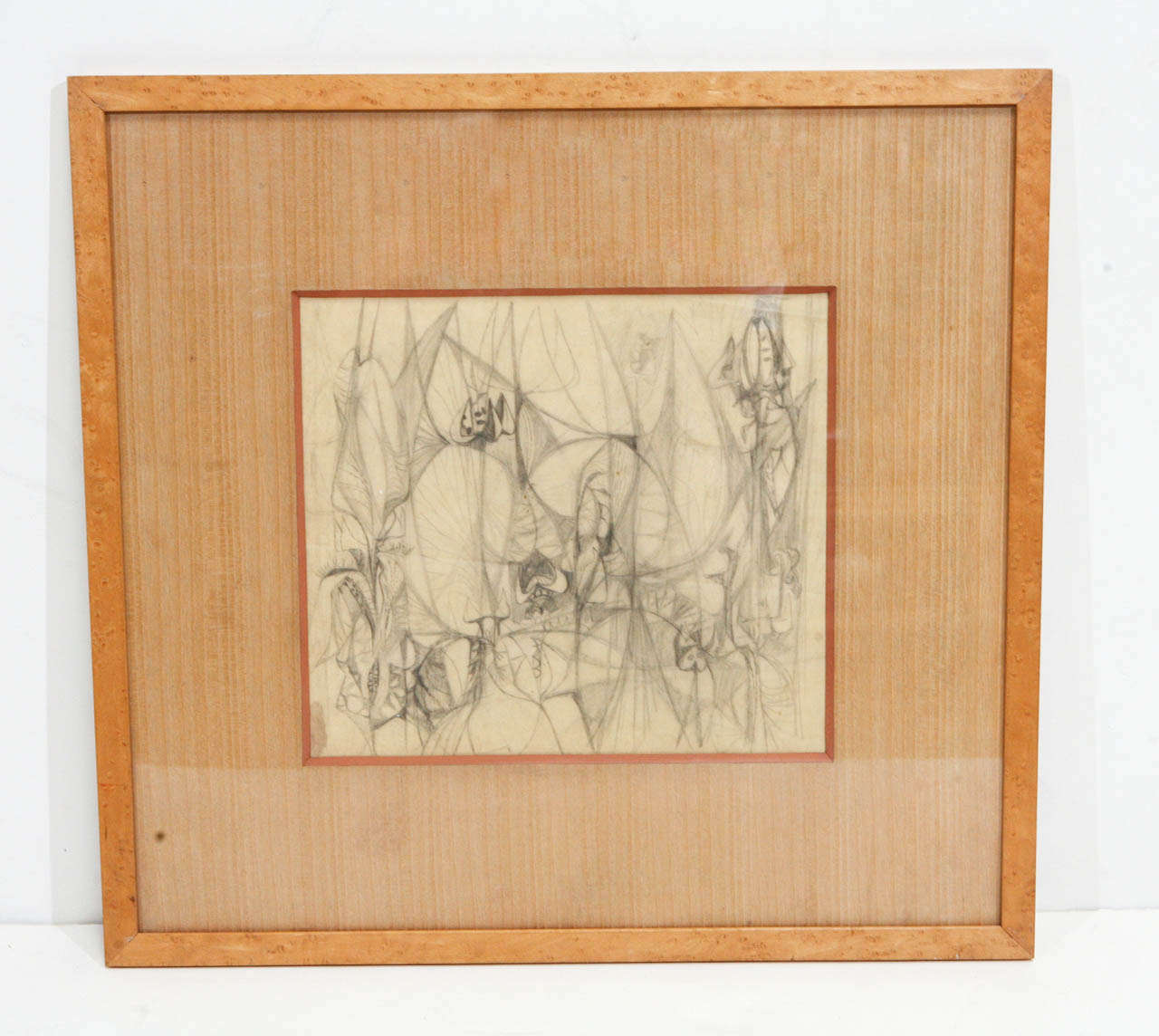 Midcentury abstract pencil sketch with light taupe matting framed in burled wood.