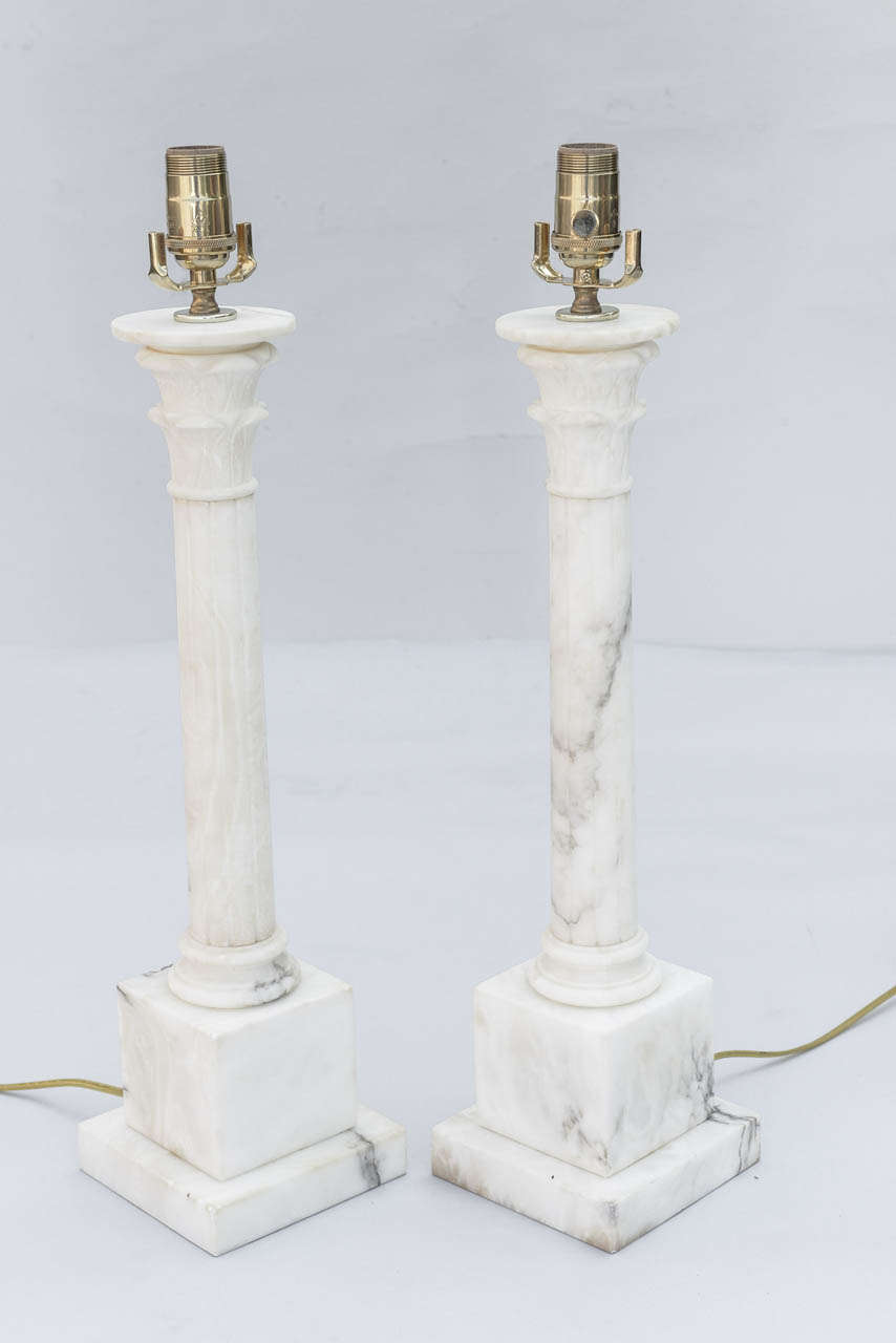 Pair of alabaster lamps, each carved as a fluted column raised on square plinth.