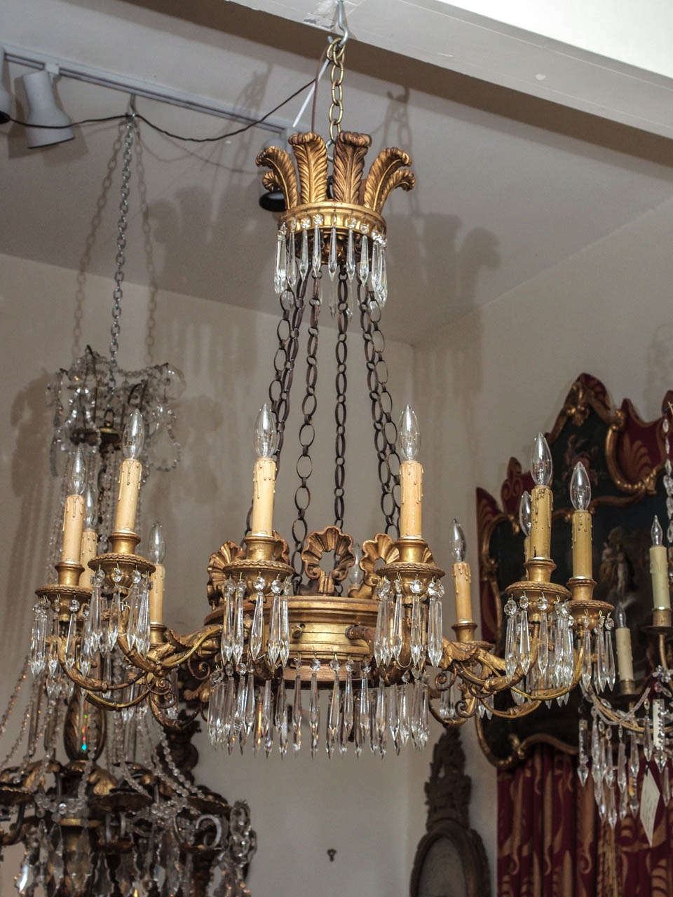 Gilt wood Chandelier with unusual gilt wood carved feather crown with gilt chains holding a gilt wood ring surmounted with gilt ribbons and gilt metal arms all decorated with crystal drops.