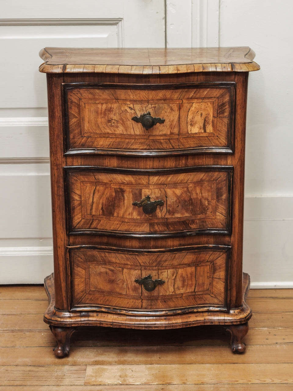 Pair of Italian Luigi XV Olive Wood Commodini with iron hardware. Three drawers and shaped front.