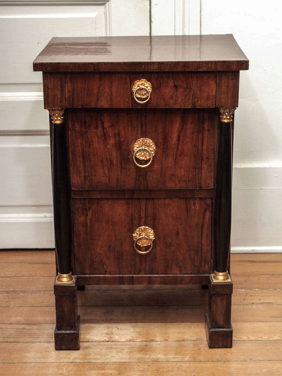 Pair of Walnut and ebonized wood Empire Commodini with three drawers.