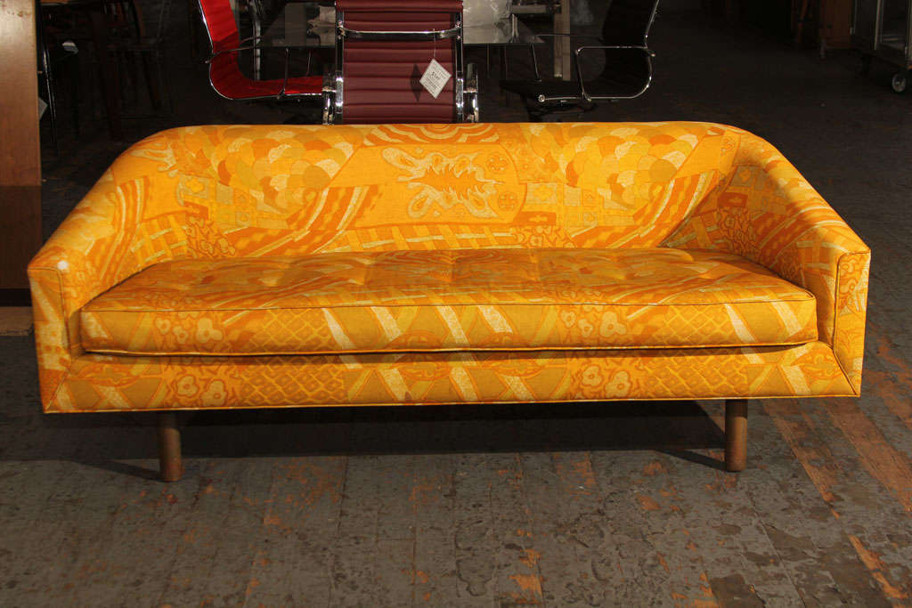 This vintage loveseat features an elegant shape with a bold print fabric in the style of  Jack Lenor Larsen.