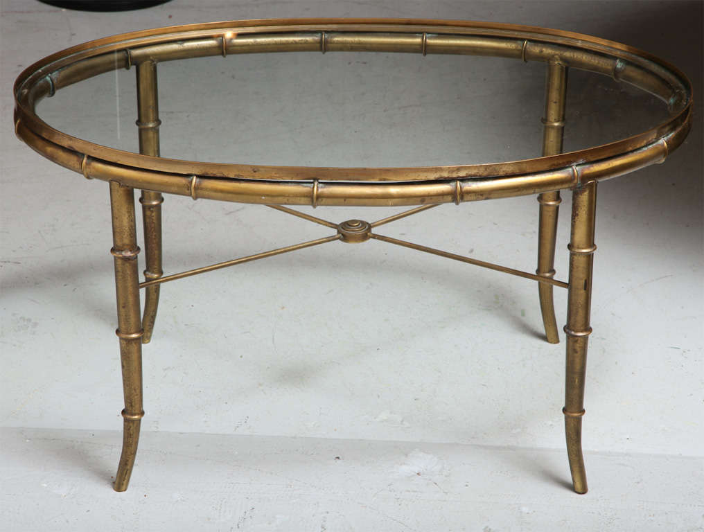 Mid-Century oval brass bamboo style coffee table with glass top.