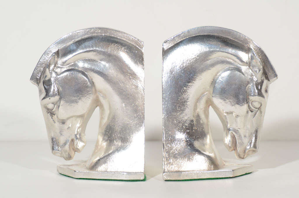 Pair of highly stylized horse<br />
head bookends in cast steel<br />
with silverplate finish.<br />
Heavy to the touch and great<br />
looking from all angles. A <br />
handsome addition to any book-<br />
case or desk.