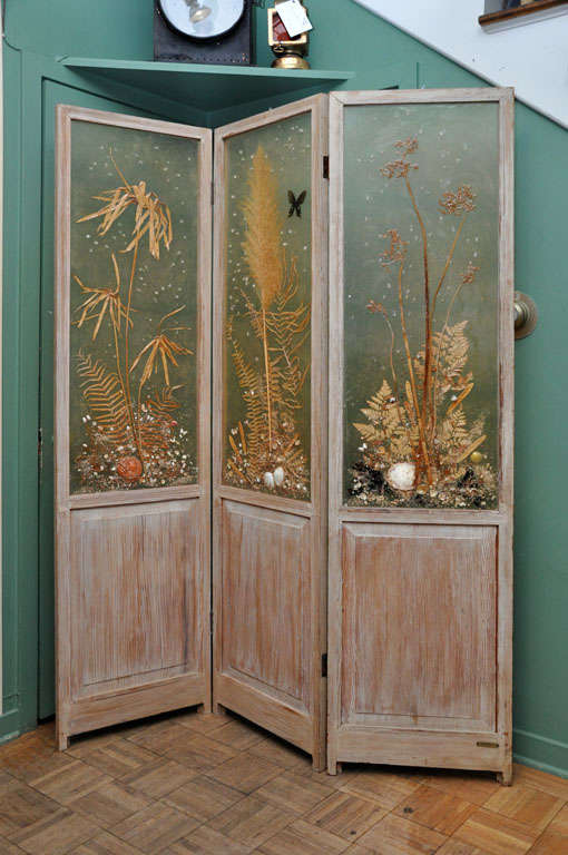 Three panel screen by Nancy Hutchings of Sea Island Georgia. Limed Pine frame with cast panels of dried plants, butterfiles and shells. Each panel measures 19.25 inches.