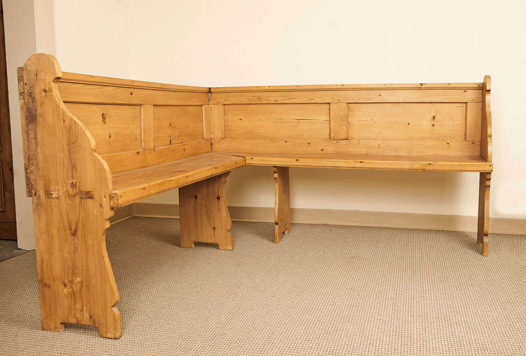 A pine corner bench ideal for a square breakfast nook.