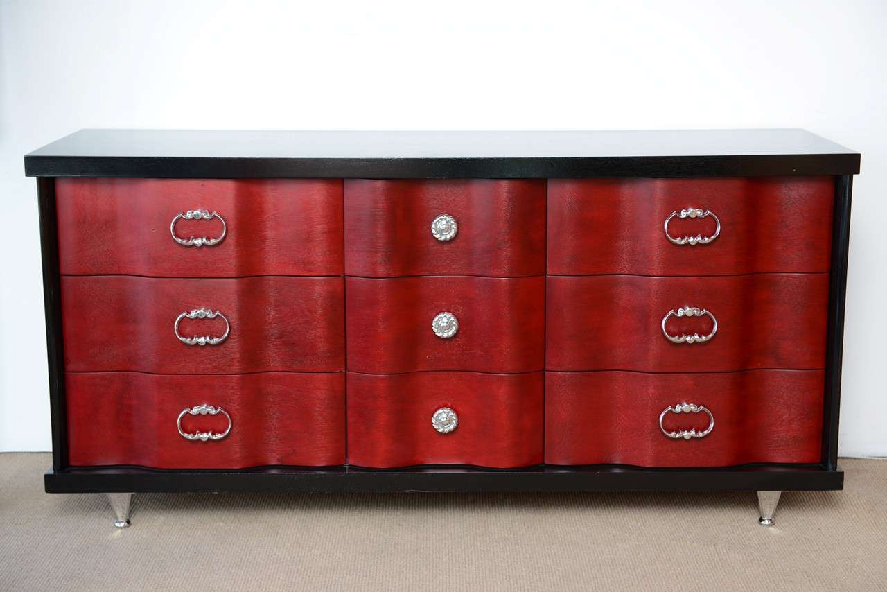 This an unique master piece with that curved lines and color that create a sexy glamour as Dorothy Draper styler. Drawer fronts have a beautiful curved, wave design. Refinished by our Restoration Division in red French wine and black stain. The