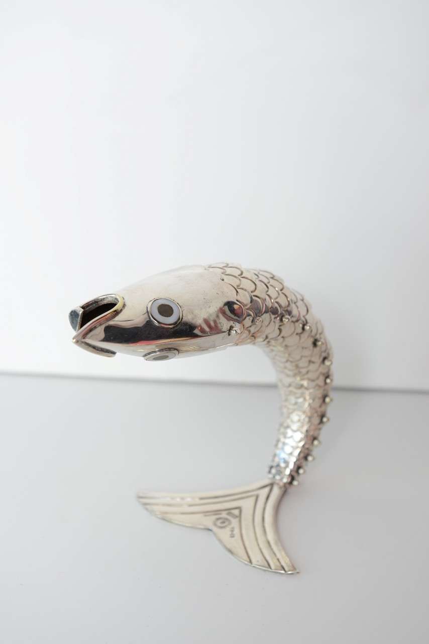 Fantastic vintage  Silver Fish Bottle Opener by famed Mexican silver artist Emilia Castillo.Unique hinged construction allow the fish to lay flat or stand curved on its tail.  12 separate hinged pieces. Eyes inlaid with abalone shell. Stamped on the