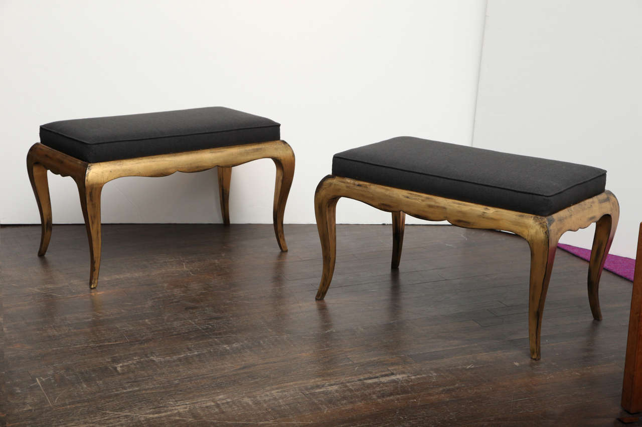 Great pair of low benches with gilded wood frames and cabriole legs. Upholstered in charcoal colored brown wool.  Very stylish benches with great scale.