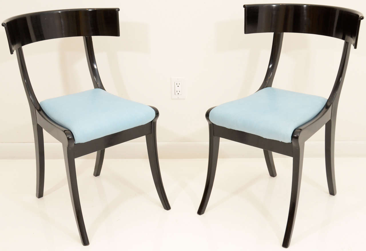 A pair of Danish ebonized Klismos chairs, Last Quarter 19th Century, of typical form with a curved backrest, with upholstered seats raised on sabre legs.