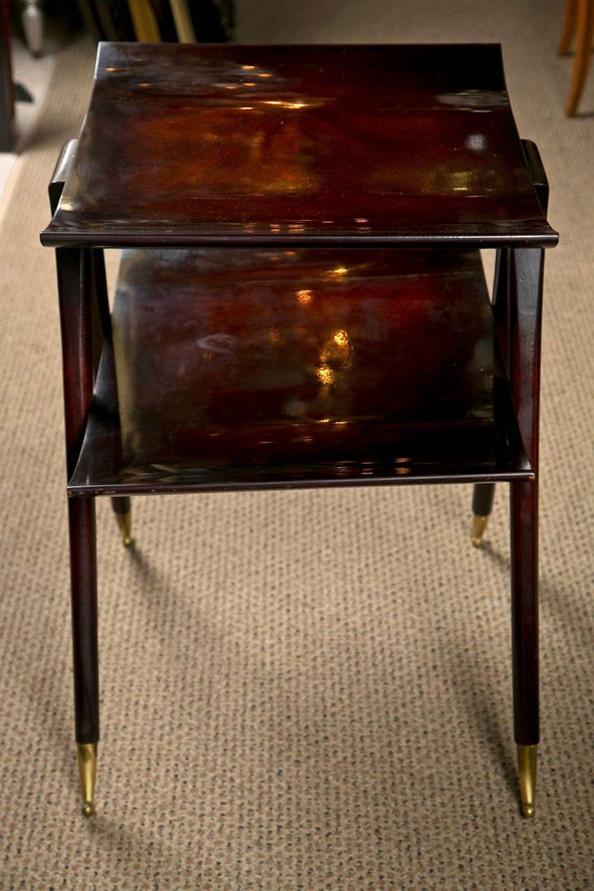 Sculptured tables in mahogany wood - Top and shelf in figured grain
mahogany wood. Unique brass shoes that indicated table is made
in Europe.
