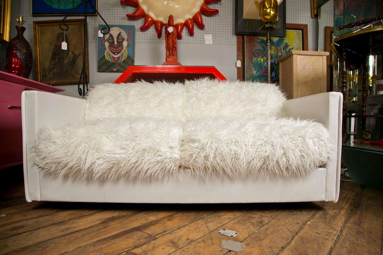 Five foot upholstered loveseat  designed by  Adrian Pearsall made by Craft Associates in the style of Paul Evans.  Cast resin  sides and back panels.- Unique design.

Upholstered in white naugahyde with faux Mongolian Fur pillows

Recently