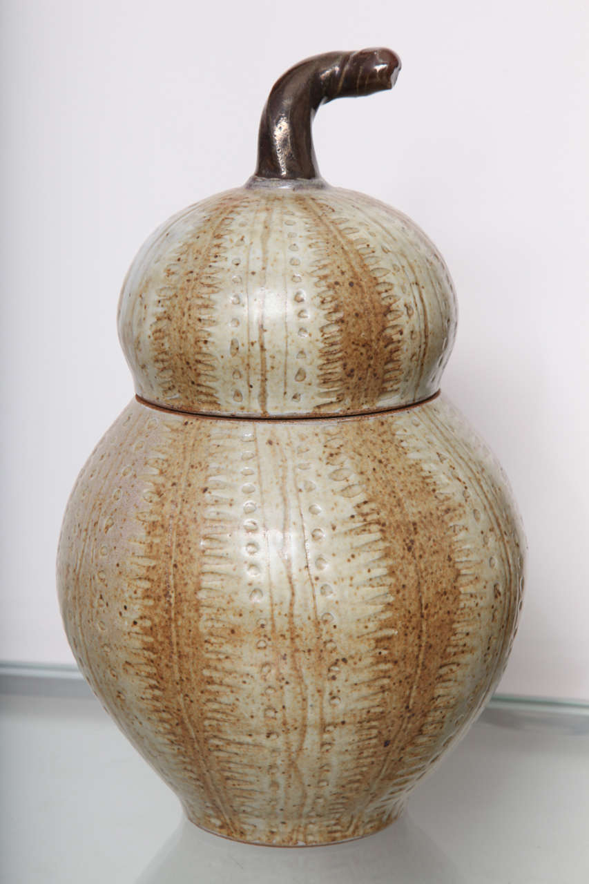 Covered jar in gourd form with incised and glazed decoration.