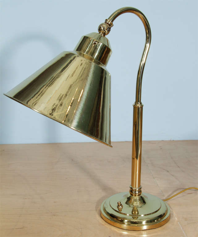New polished brass finish and wide articulating shade with white enamel interior. Multiples available.