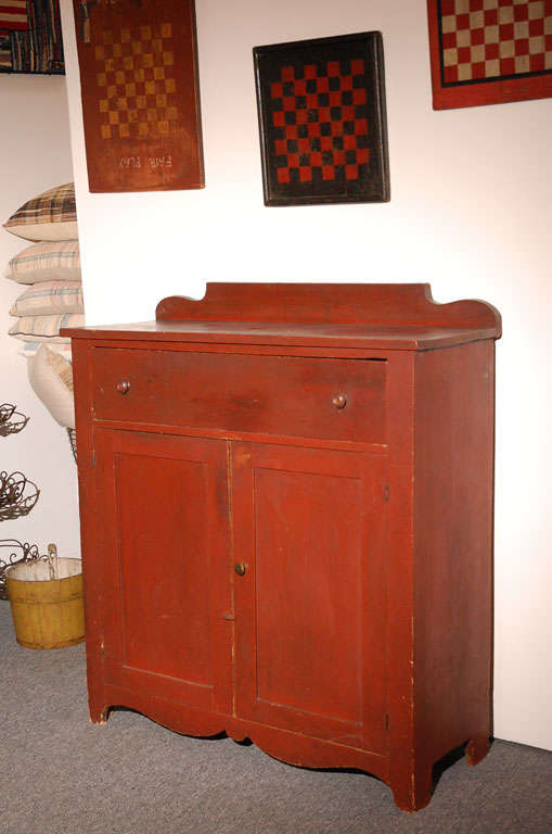 Fantastic form and condition original red painted jelly cupboard with a wonderful scalloped skirt. This Great cupboard has one large drawer over two doors.The surface is super and very strong.The sides have wonder cut out feet too. Great addition to